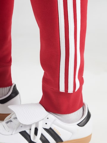 ADIDAS ORIGINALS - Tapered Calças em vermelho