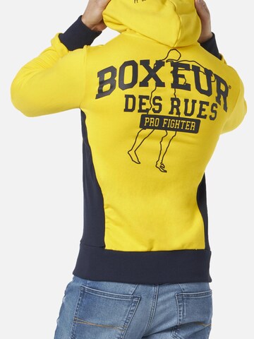 Boxeur des Rues - Sudadera 'Herren Hoodie Fitted Boxeur des Rues mit Reißverschluss und Kapuze, Gelb mit Marineblau, Baumwolle' en amarillo