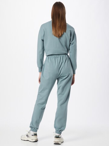 ABOUT YOU Tapered Trousers 'Naomi Sweat Pants' in Green