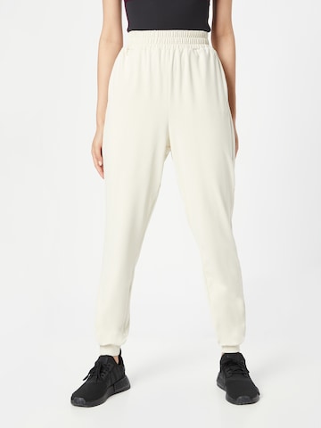 Effilé Pantalon de sport 'Flow' HKMX en beige : devant