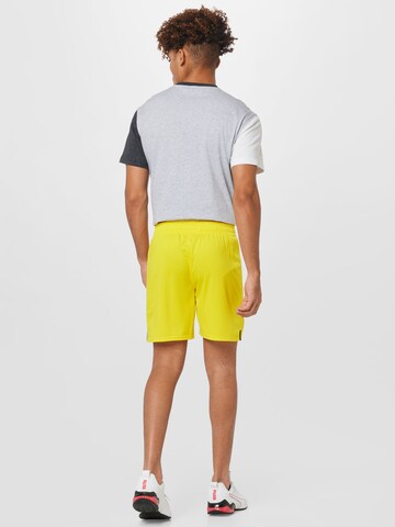 PUMA - Regular Calças de desporto em amarelo