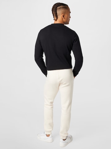 ADIDAS ORIGINALS Zwężany krój Spodnie 'Adicolor Essentials Trefoil' w kolorze biały