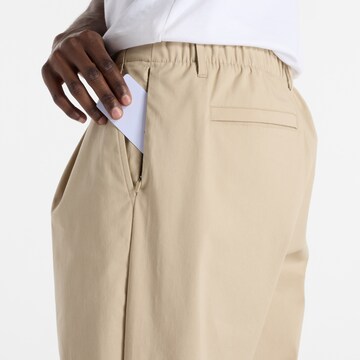 Loosefit Pantalon à pince 'Athletics' new balance en gris