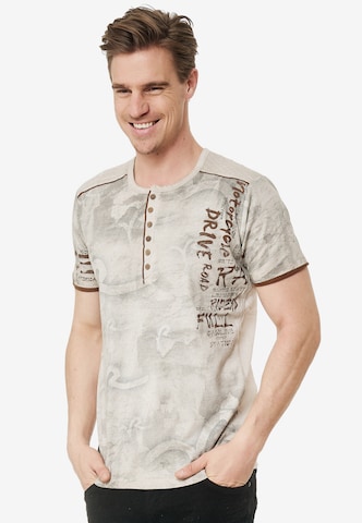 Rusty Neal T-Shirt mit lässigem Allover-Print in Beige: predná strana