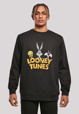 F4NT4STIC Sweatshirt 'Looney Tunes Group Faux Pocket' in Zwart: voorkant