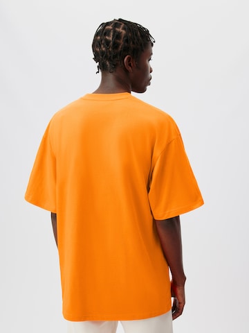 ABOUT YOU x Kingsley Coman Koszulka 'Aaron' w kolorze pomarańczowy