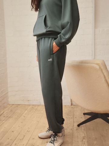 Next Tapered Trousers in Green: front