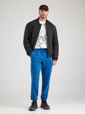 Nike Sportswear Tapered Broek 'CLUB' in Blauw