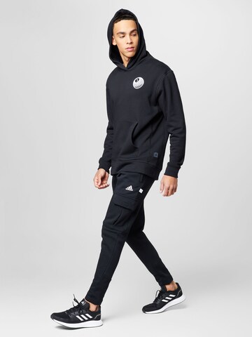 ADIDAS SPORTSWEAR - Tapered Calças de desporto 'Future Icons Fleece ' em preto