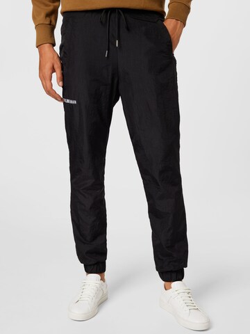 Han Kjøbenhavn Tapered Trousers in Black: front