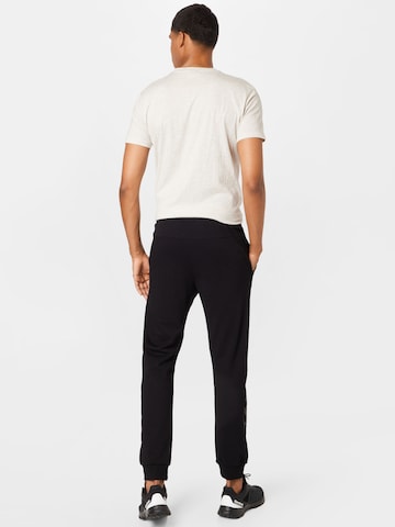 Hummel - Tapered Pantalón deportivo en negro