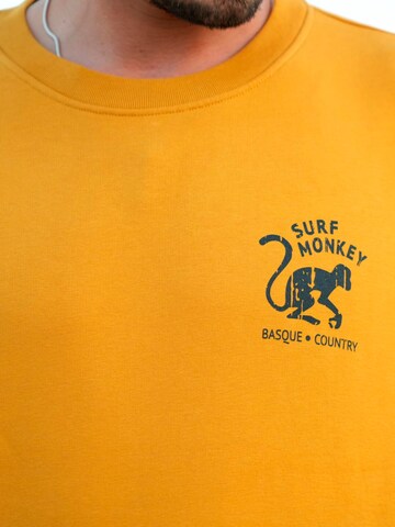 Surf Monkey - Sudadera 'Rette das Ozean' en naranja