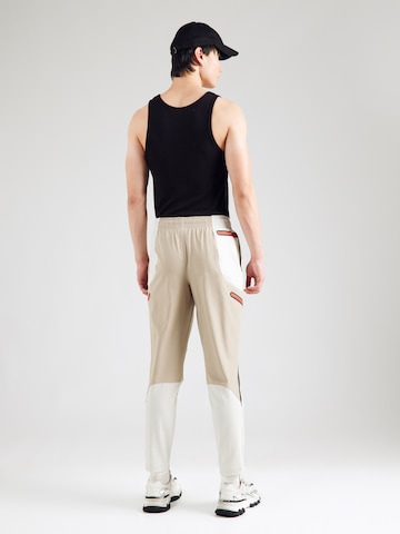 Regular Pantaloni sport 'Unstoppable' de la UNDER ARMOUR pe alb