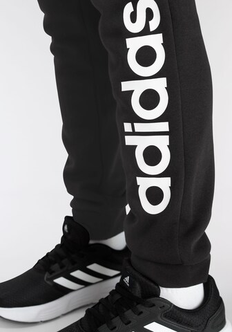 ADIDAS SPORTSWEAR Tapered Sports trousers 'Essentials Linear Logo' in Black