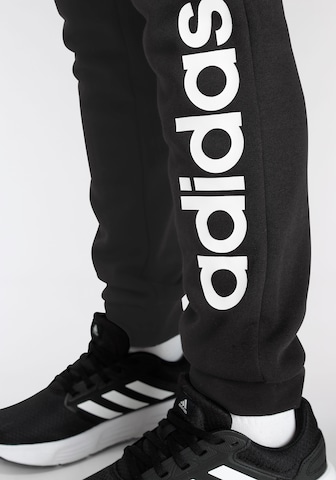 ADIDAS SPORTSWEAR - Tapered Calças de desporto 'Essentials Linear Logo' em preto