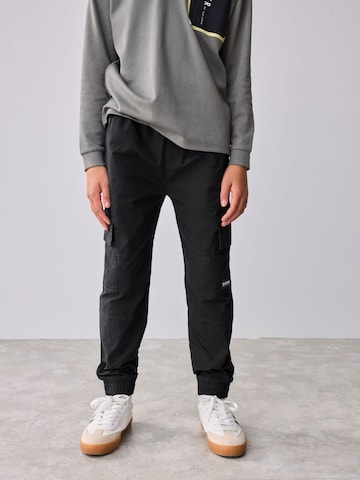 Baker by Ted Baker Tapered Trousers in Black: front