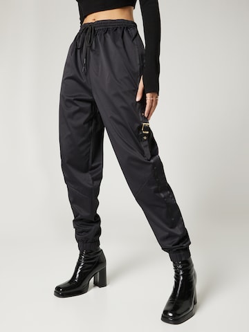 Hoermanseder x About You Tapered Pants 'Elena' in Black: front