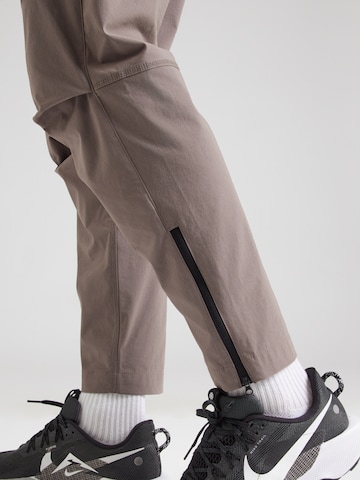 pelēks Nike Sportswear Pakapēniski sašaurināts piegriezums Bikses