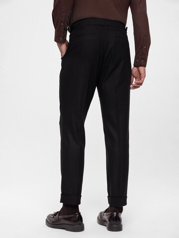 Antioch Tapered Pleat-front trousers in Black