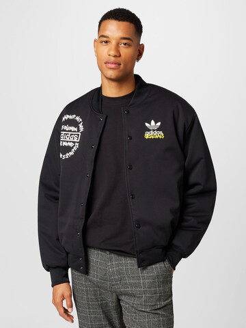 ADIDAS ORIGINALS - Chaqueta de entretiempo 'Graphics Unite ' en negro: frente