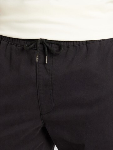 JOHN DEVIN Tapered Trousers in Black