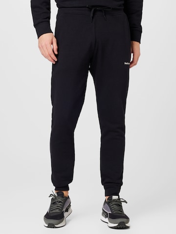 PEAK PERFORMANCE Tapered Trousers in Black: front