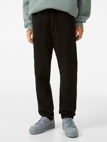 Bershka Regular Trousers in Black: front