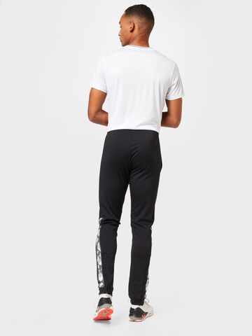 Effilé Pantalon de sport DUNLOP en noir