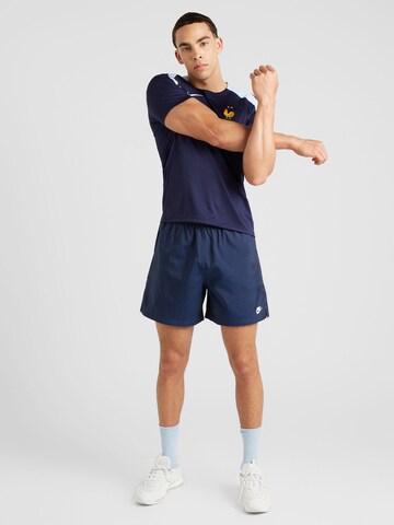 Largi Pantaloni 'Club' de la Nike Sportswear pe albastru