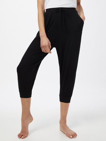Tapered Pantaloni sport de la CURARE Yogawear pe negru: față