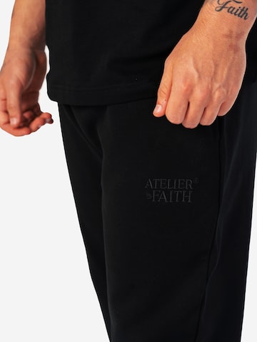 Loosefit Pantaloni sportivi 'AOF FLARED JOGGER' di ATELIER OF FAITH in nero