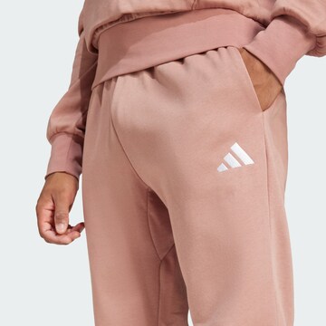 ADIDAS SPORTSWEAR Tapered Workout Pants 'Essentials Feelcozy' in Pink