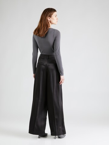 Wide leg Pantaloni con pieghe di REMAIN in nero