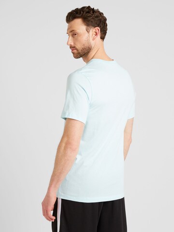 Nike Sportswear T-shirt 'SWOOSH' i blå