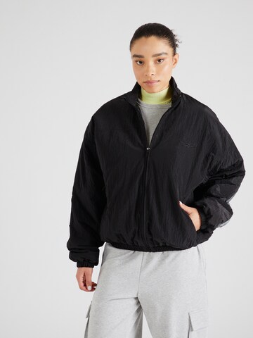 Reebok - Chaqueta de entretiempo en negro: frente