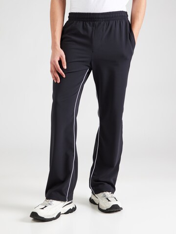 UNDER ARMOUR Loose fit Sports trousers in Black: front