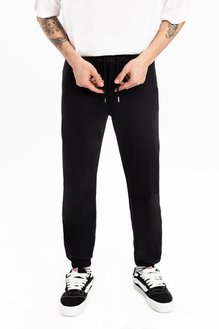 UNIQVIBE Tapered Trousers in Black: front