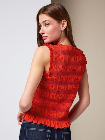 Haut Next en rouge