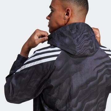 Jachetă de trening 'Future Icons Allover Print' de la ADIDAS SPORTSWEAR pe negru