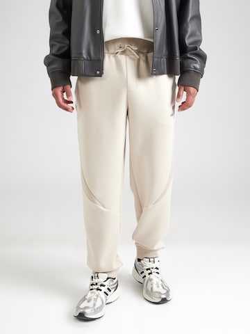 GUESS Tapered Παντελόνι φόρμας 'RYOTA' σε καφέ: μπροστά