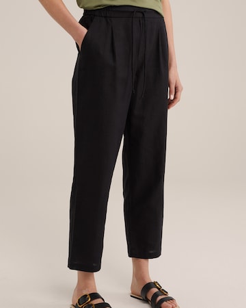 WE Fashion Loose fit Trousers in Black: front