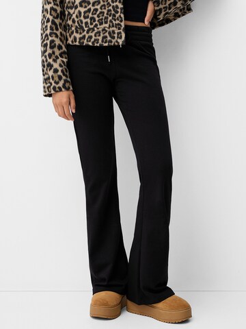 Bershka Flared Trousers in Black: front