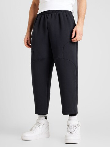 Tapered Pantaloni sportivi 'Unstoppable' di UNDER ARMOUR in nero: frontale