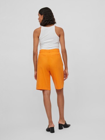 VILA Normalny krój Spodnie w kolorze pomarańczowy