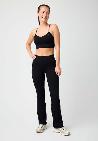 OCEANSAPART Flared Workout Pants 'Maya' in Black: front