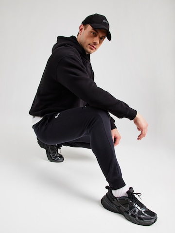 UNDER ARMOUR Tapered Workout Pants in Black