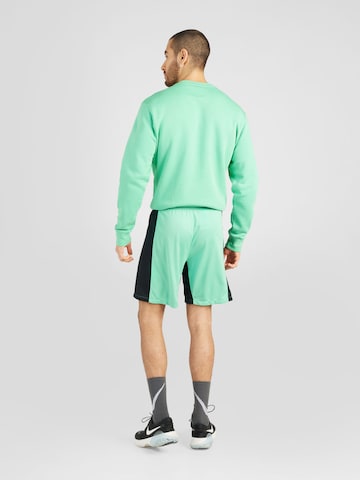 NIKE Regular Workout Pants in Green