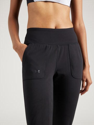 Tapered Pantaloni sport 'Motion' de la UNDER ARMOUR pe negru