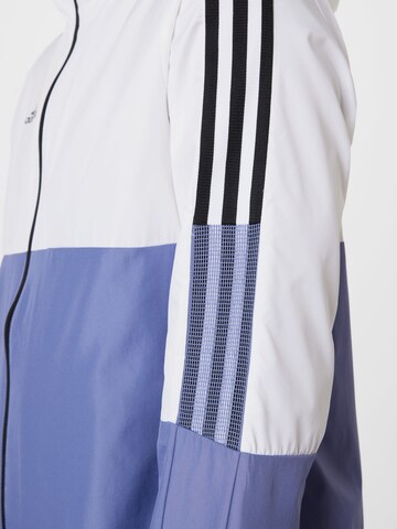 ADIDAS PERFORMANCE Sportovní bunda 'Tiro' – modrá