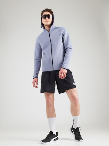 Bluză cu fermoar sport 'Evostripe' de la PUMA pe albastru